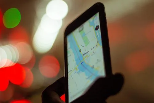 Hand holding a phone showing a map